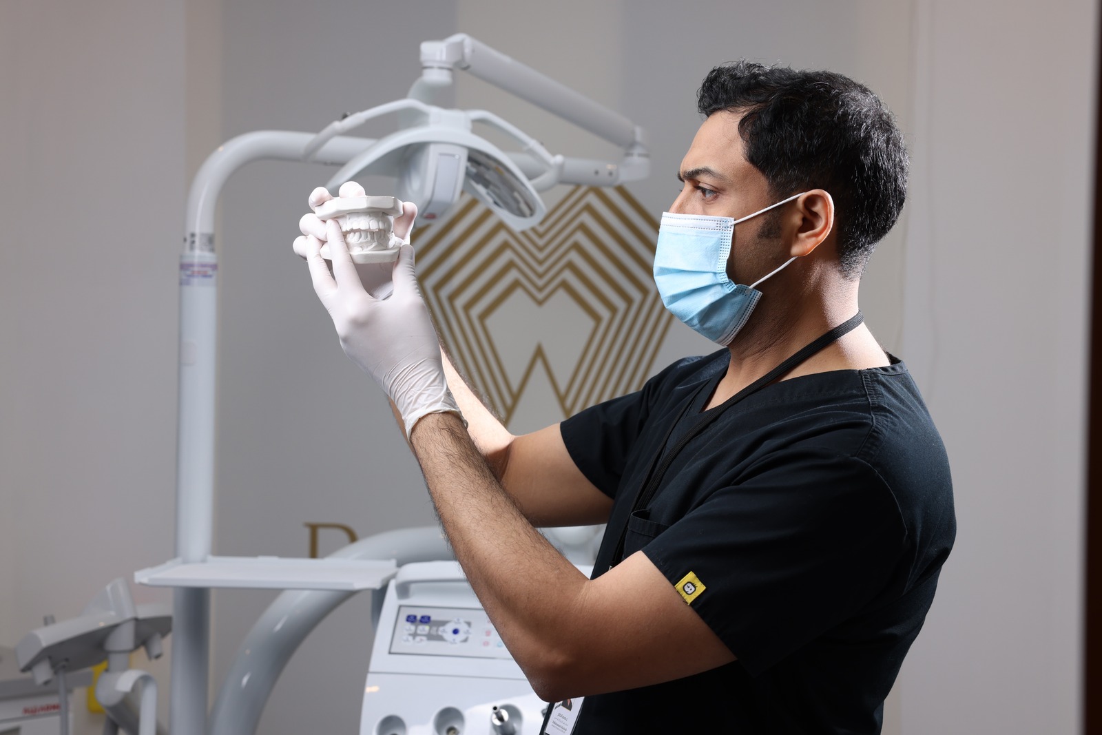 Dr. Mohammed Alsaleh reviewing a dental model